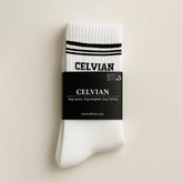 Celvian white crew socks 3-pack with black logo and stripe detail, packaged with label reading “Stay active. Stay inspired. Stay Celvian.” minimalist studio shot.