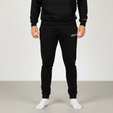 Celvian Distinctive black pants, front view highlighting embroidered logo on thigh, tapered fit with cuffed ankles, studio shot.