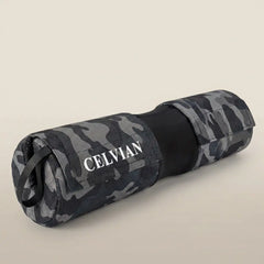Celvian obsidian camo barbell pad in rolled form, shown in studio view with black center support, Velcro straps, and logo detail.