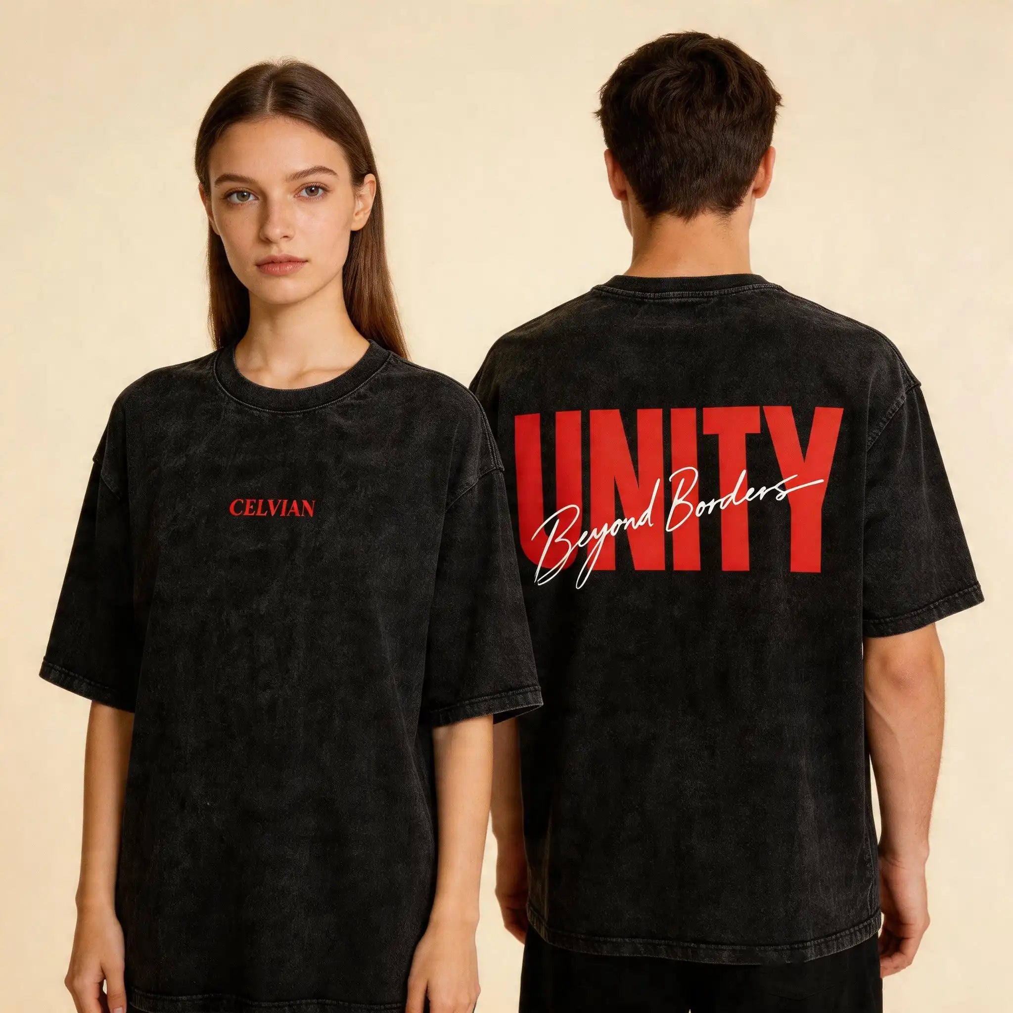 Front and back view of the Celvian Beyond Borders T-Shirt in washed black, shown on male and female models with a minimal red CELVIAN chest logo and bold red UNITY back graphic on a beige studio background.