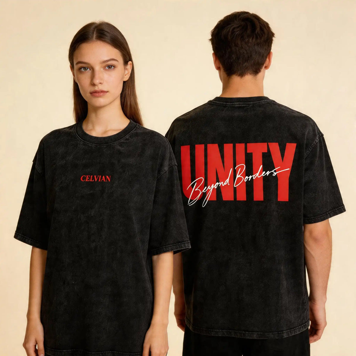 Front and back view of the Celvian Beyond Borders T-Shirt in washed black, shown on male and female models with a minimal red CELVIAN chest logo and bold red UNITY back graphic on a beige studio background.