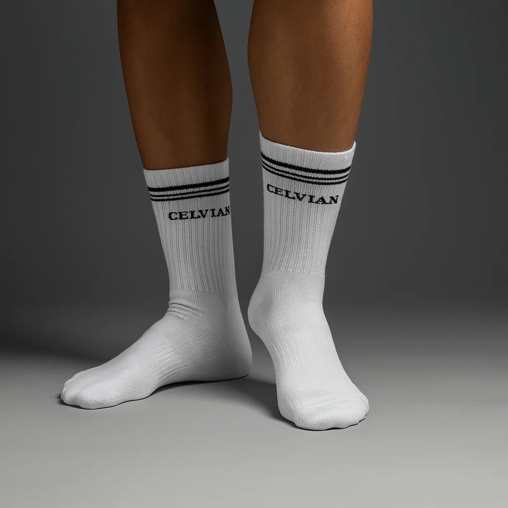 Celvian white crew socks with black logo and double stripe detailing, front view on model showcasing ribbed cotton texture and snug fit.