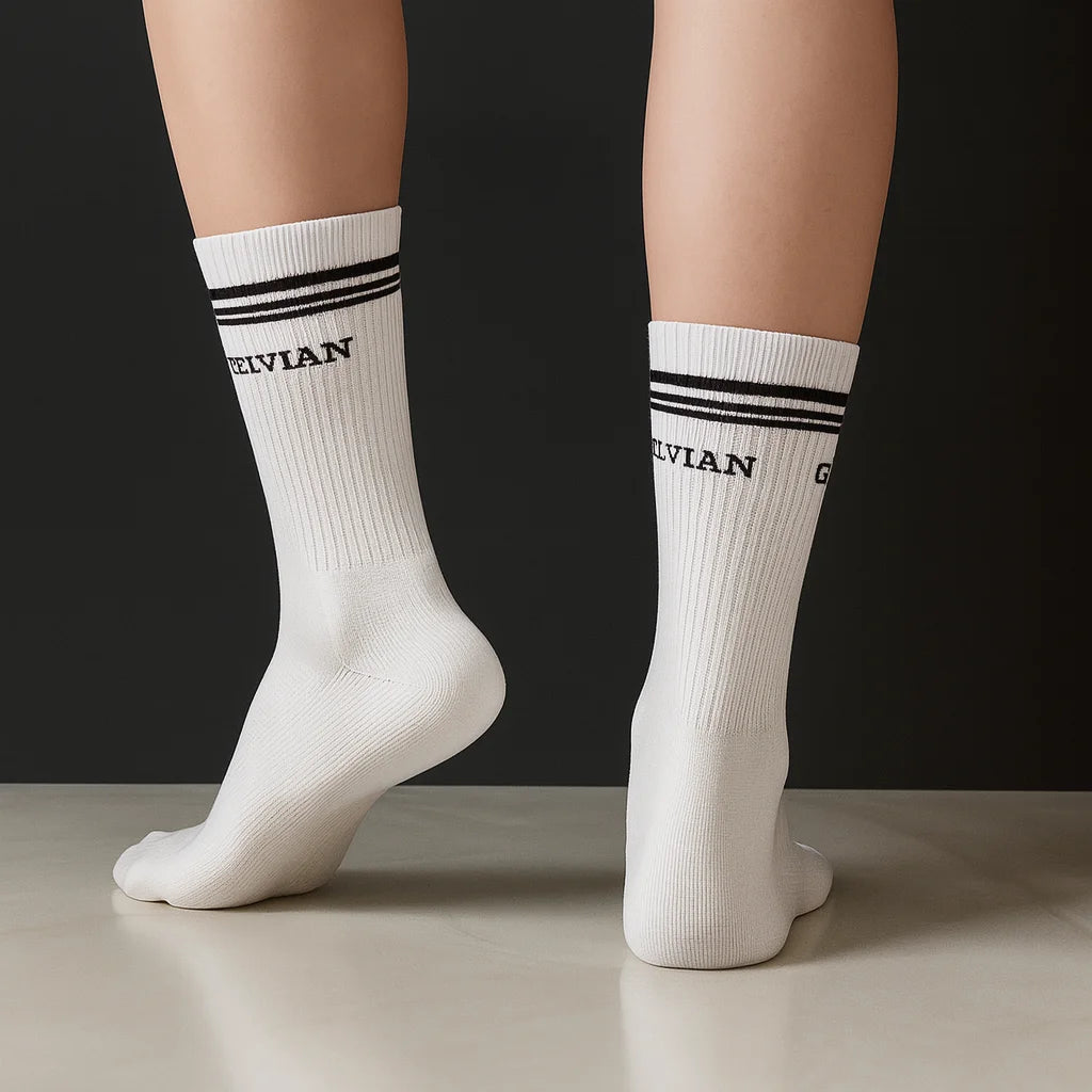 Celvian white crew socks with black logo and double stripe design, rear view on model showcasing ribbed texture and athletic fit.