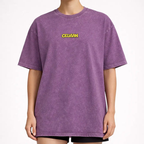 Front view of purple acid-wash oversized t-shirt with small yellow Celvian logo on chest.