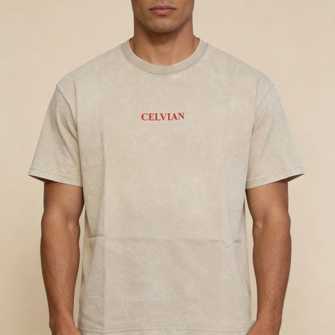 Front view of beige washed oversized t-shirt with small red Celvian logo on chest.
