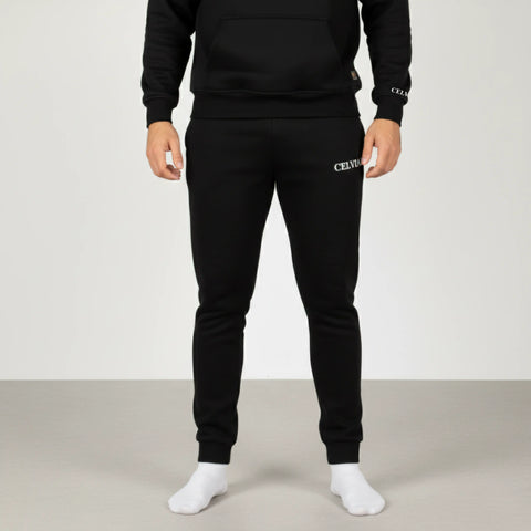 Person wearing a black CELVIAN pants on a white background