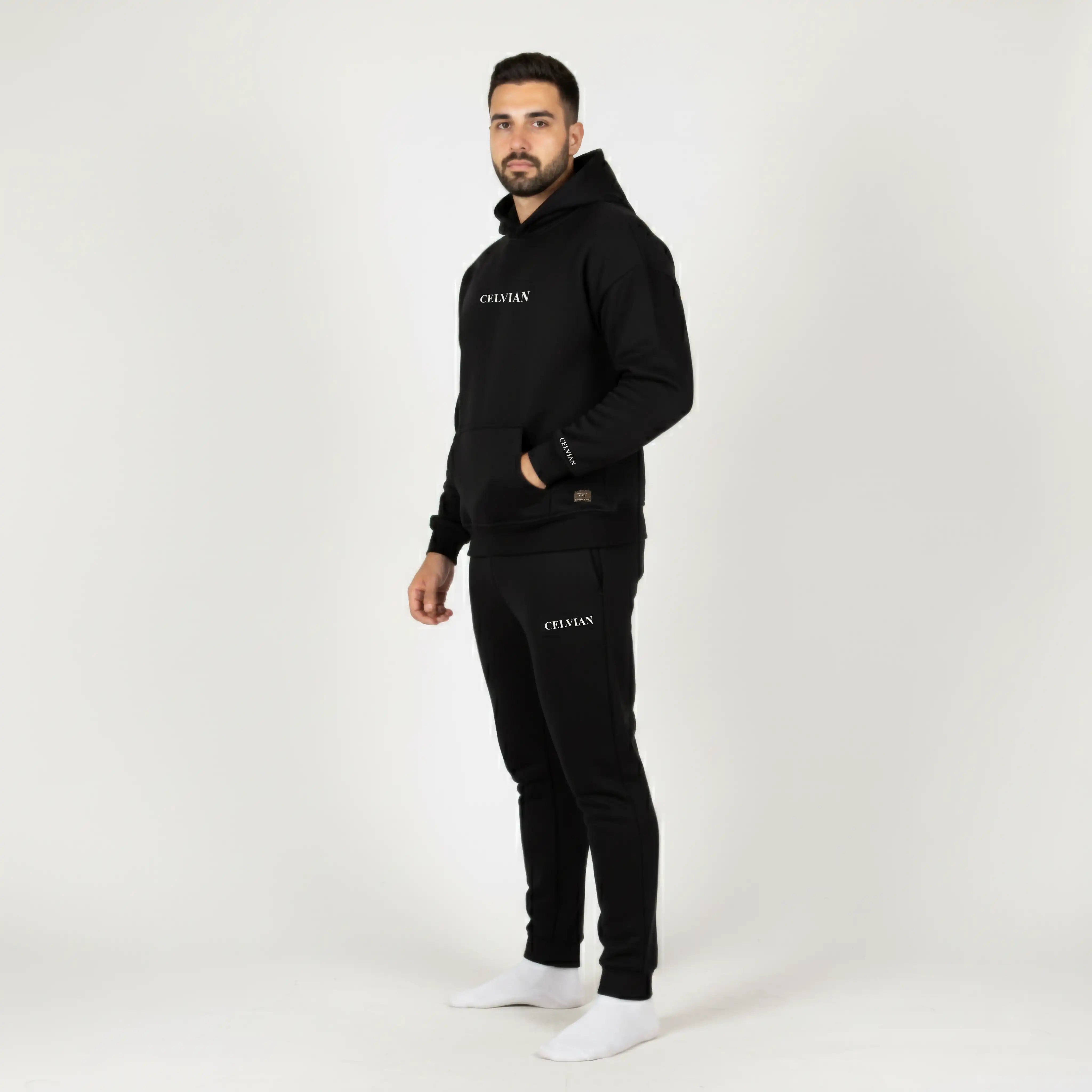 Man wearing a black tracksuit with 'CELVIAN' branding on a white background