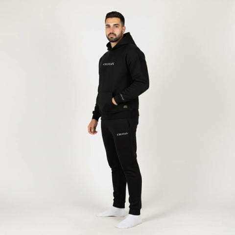 Man wearing a black tracksuit with 'CELVIAN' branding on a white background
