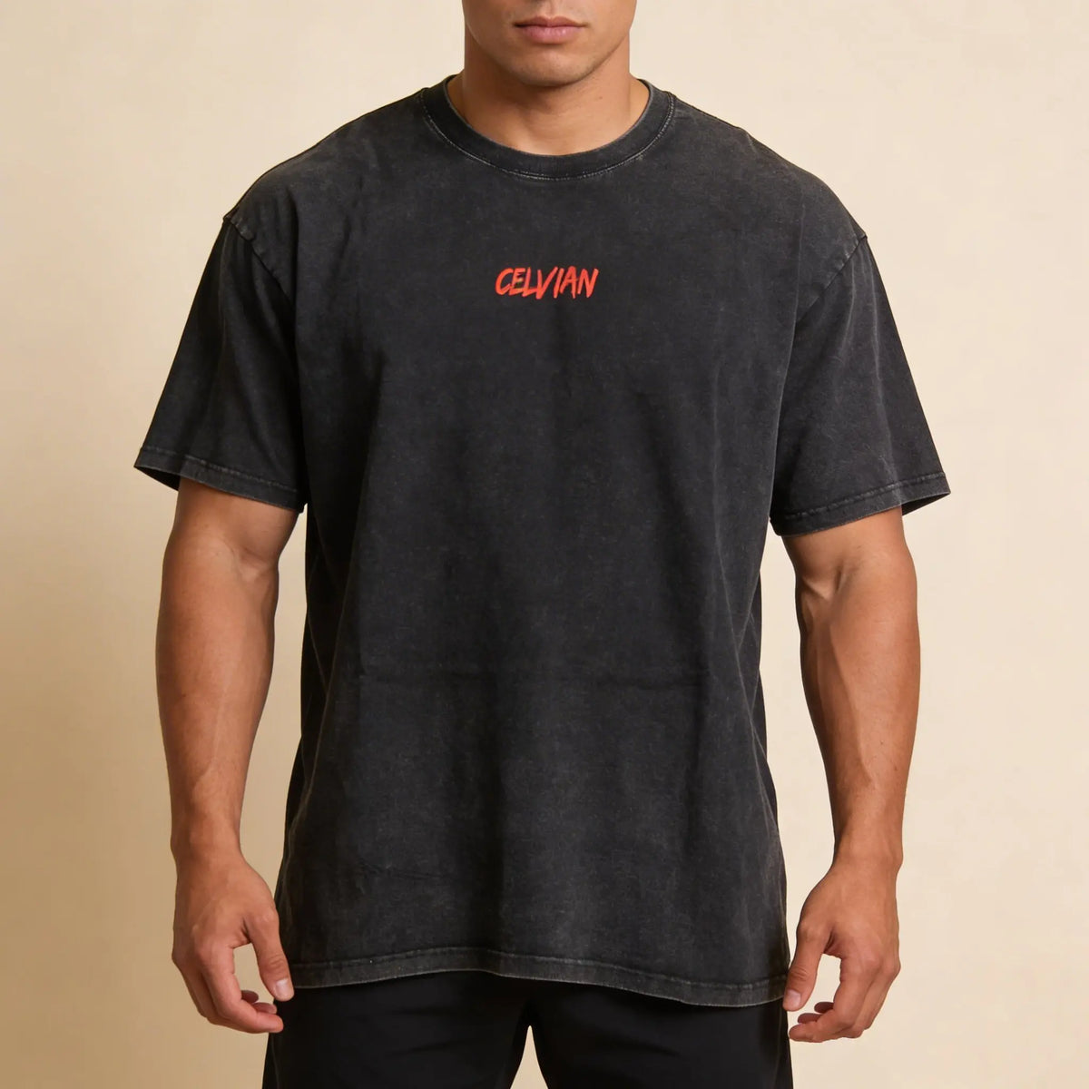 Male model wearing the Celvian No Limits T-Shirt in washed black, front view with small red CELVIAN chest logo and oversized fit.